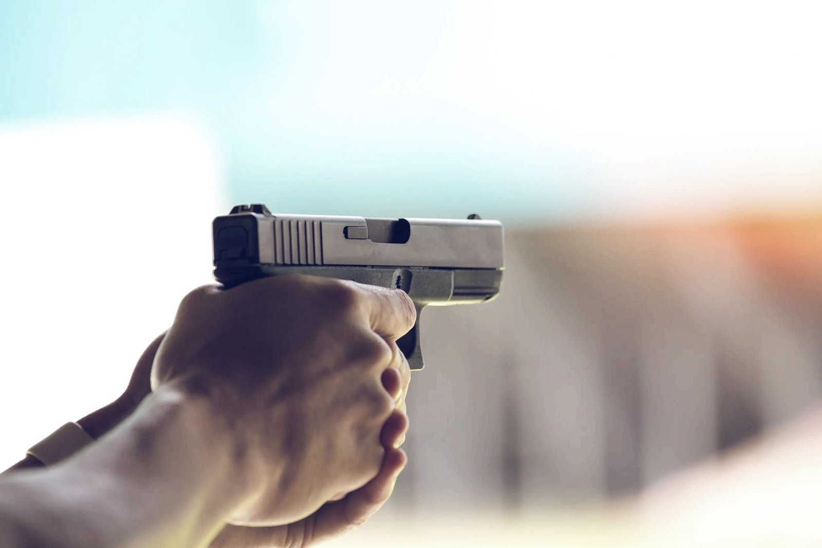 A shooter aiming a pistol.